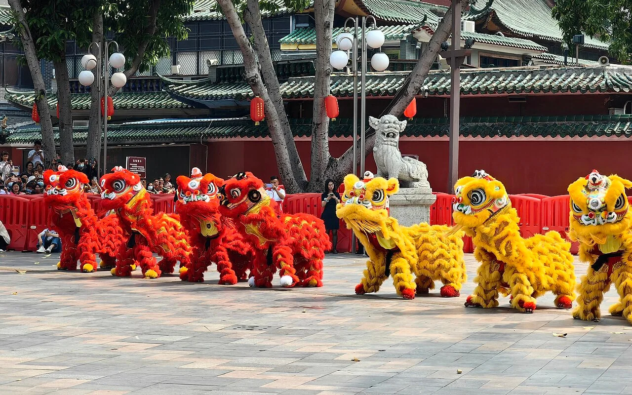 Formation of red and yellow lion-dance teams outside the Foshan Ancestral Temple complex