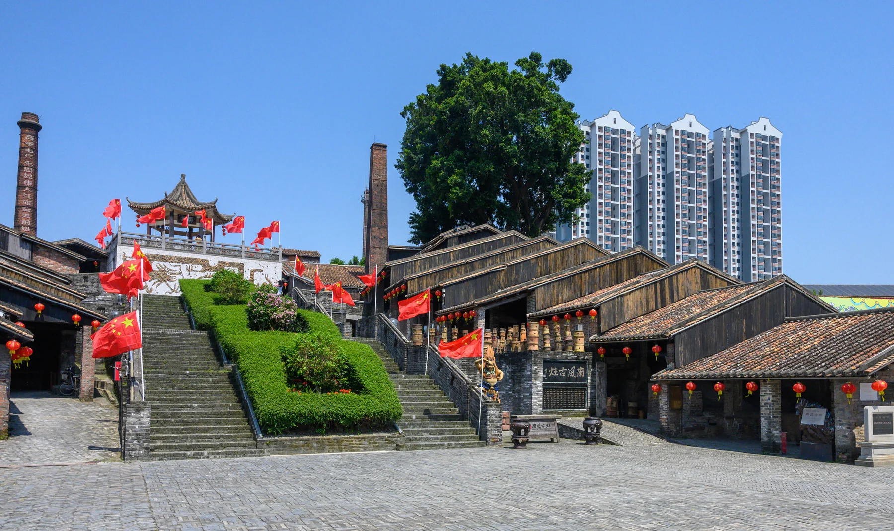 A dated wide view of steps, sloping roofs and surrounding structures at Nanfeng Kiln