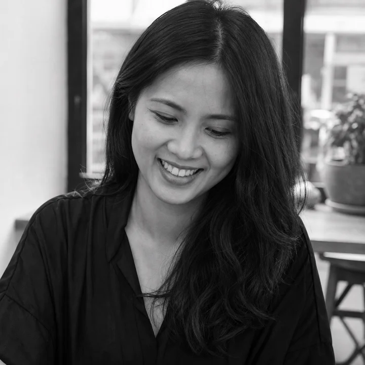 Black-and-white editorial portrait of Priya Nair, a fictional Foshan Living author persona