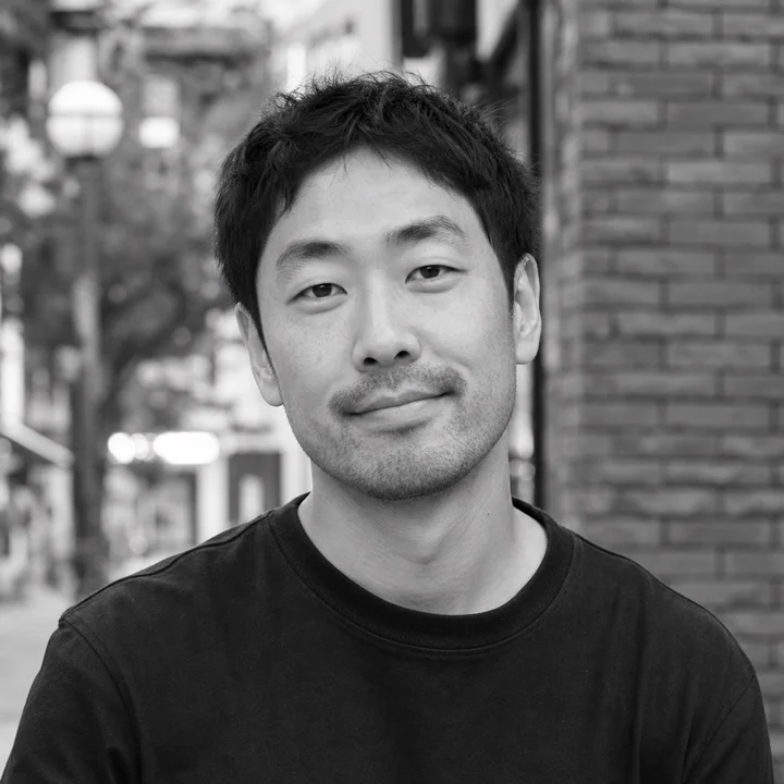Black-and-white editorial portrait of Tom Ashworth, a fictional Foshan Living author persona